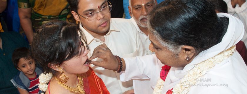 Amma giving darshan to a couple