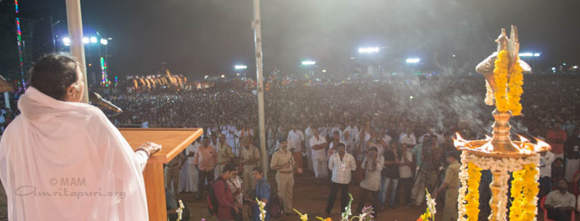 Amma addressing a crowd of people