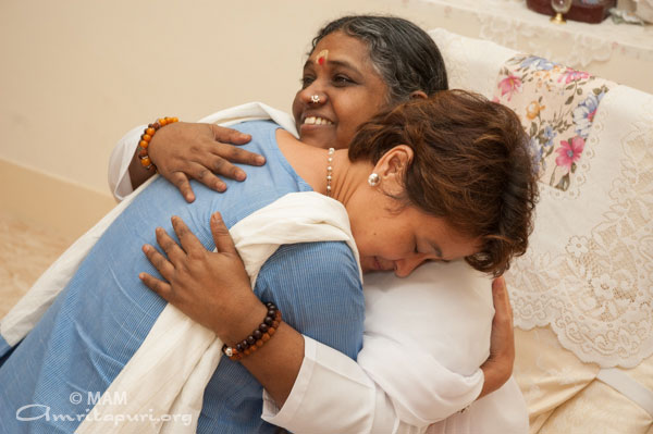 Amma embracing a woman