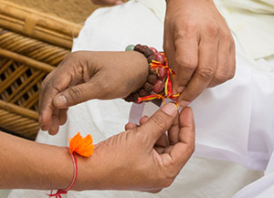 Tying rakhi to Guru