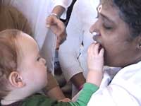 Amma cooperates with a baby