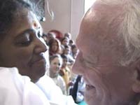 Amma giving darshan to a man in Paris