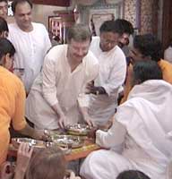 Amma serves food to devotees