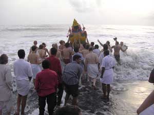 Ganesha statue being merged into the ocean