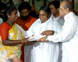 Amma handing out pensions to a widow