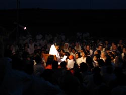 Amma singing bhajans with the tour group