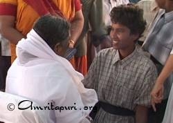 Amma giving darshan to a soldier of the Tamil Tigers in Sri Lanka