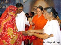 Amma on stage distributing house keys