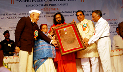 Swamiji accepting award on Amma's behalf