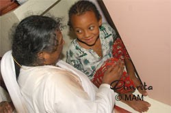 Amma playing with a child
