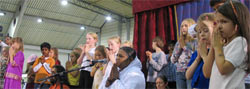 Amma on stage with children in Germany