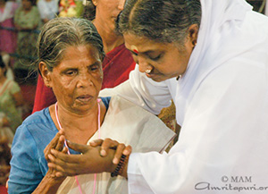 Amma receives in her feet every thorn of this earth