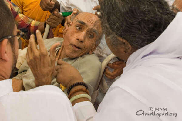 Amma consoling a sick person during darshan on 10 Jan 2010