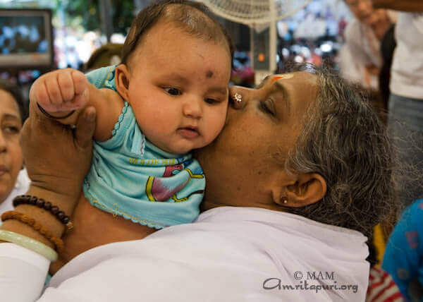 Amma gives Darshan to a small baby