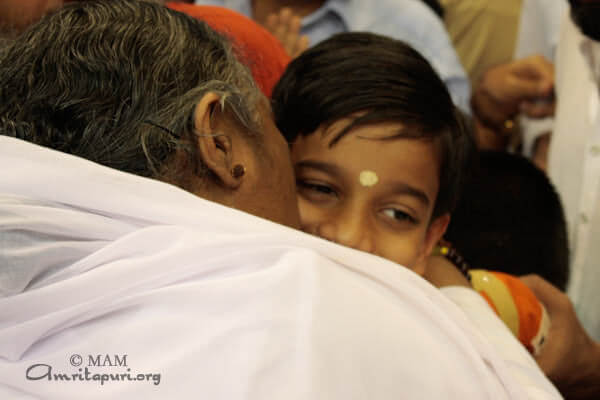 Amma gives darshan to a boy in Kovai, 2010