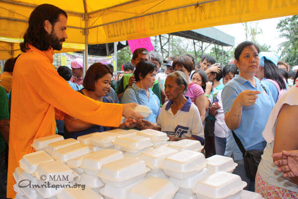 Br. Shantamrita distributing food materials