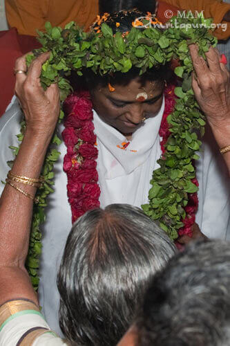 Garlanding Amma when she arrived at the Ashram in Kaimanam, Tiruvananthapuram on 22 Jan 2010