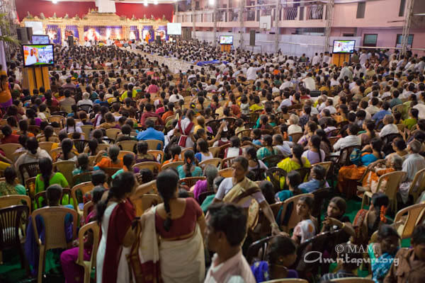 Devotees listening to Amma