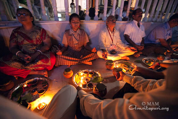 Devotees participating in puja are in meditation
