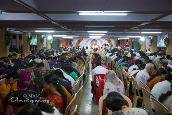 Devotees participating in puja