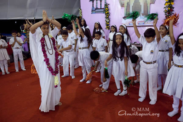 Amrita Vidyalayam children performing a dance to Amma's song