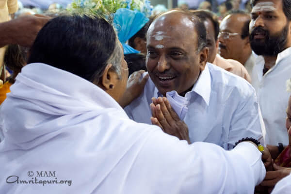 Amma giving darshan to a man in Vasanth Kunj, 2010