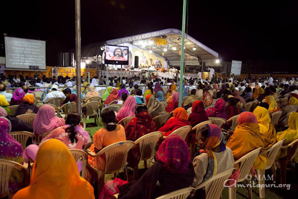 Devotees singing bhajans with Amma