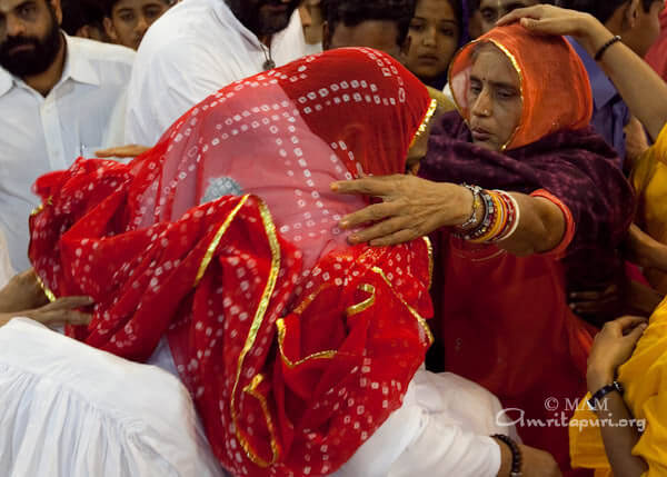 Devotees dressing Amma in chunri as Devi
