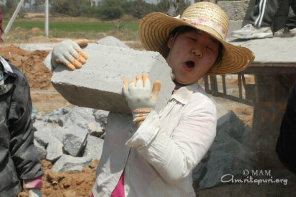 Student carrying a heavy block