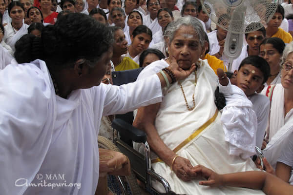 Amma sweetly touching her Mother Damayanti's face to console her