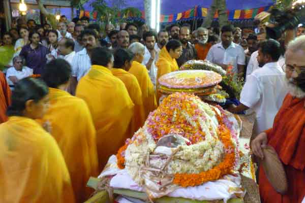 Brahmacharinis circumbulating the body and offering flowers