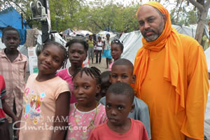 Brahmachari Dayamrita with children in Haiti