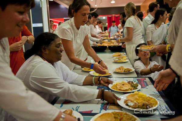 Amma serving prasad at the retreat