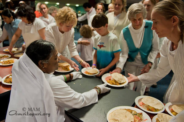 Amma giving lunch prasad at the retreat