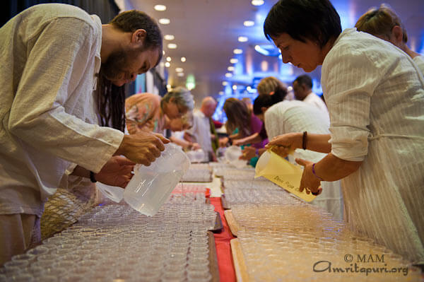 Devotees preparing the distribution of the holy water for everybody