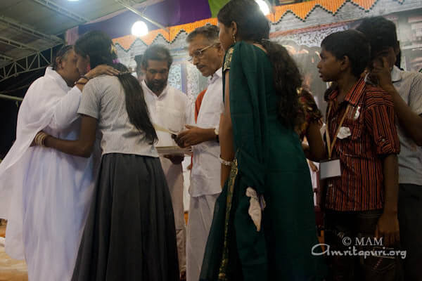 Amma giving away Vidyamritam educational scholarships to poor students