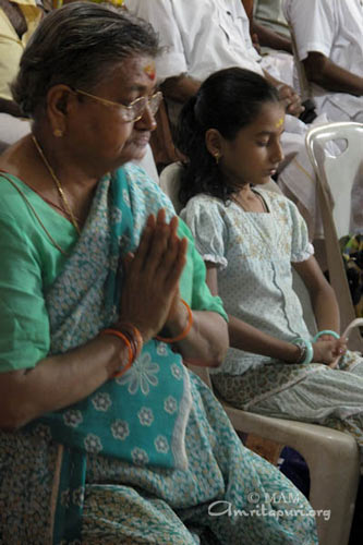 Devotees participating in the Puja