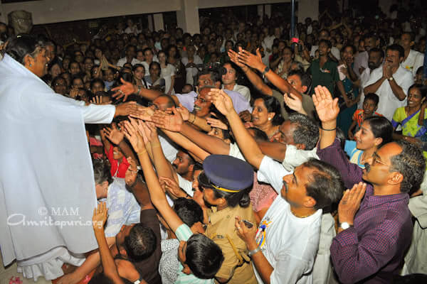 Devotees throng for a touch of Amma