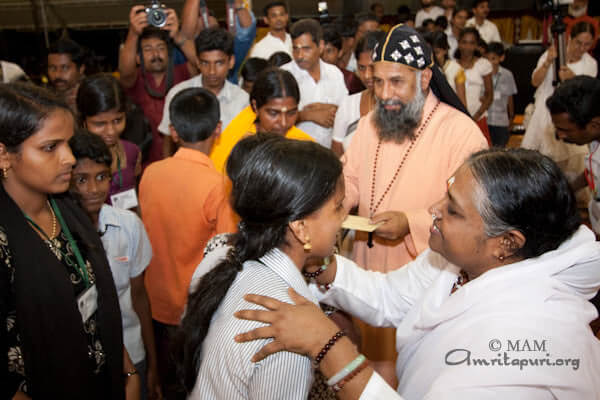 Recipients of Vidyamritam scholarships receiving Amma's darshan