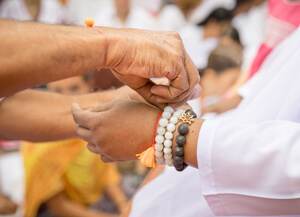 Tying Rakhi on Amma’s hand