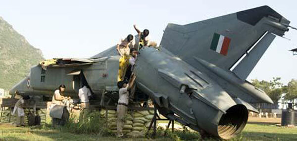 students climbing atop a MiG-23 aircraft