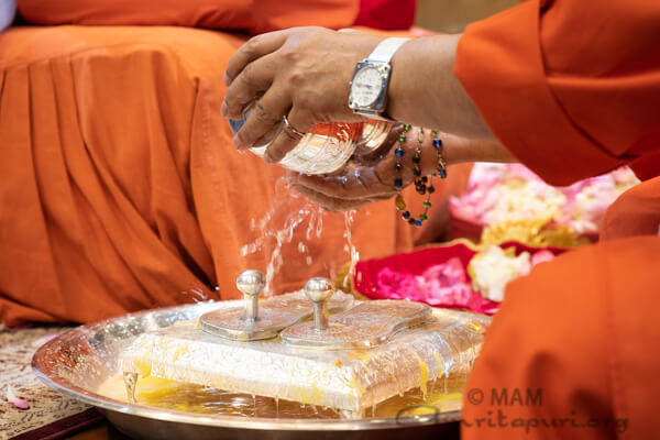 Swamiji performing Amma's Paduka Puja