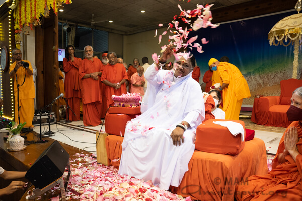 Amma throwing flower petals