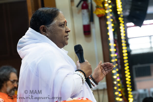 Amma speaking to the devotees