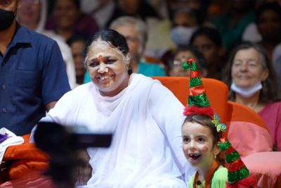 Amma watching the Christmas celebrations in Amritapuri