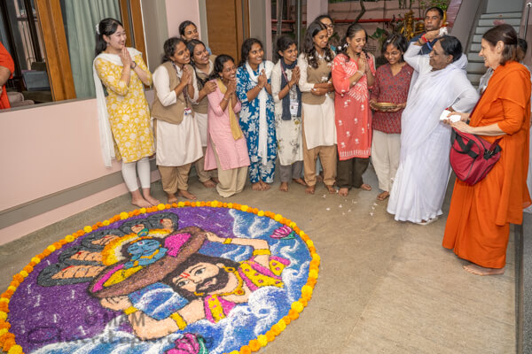 Onam arrives at Amritapuri with flowers, creativity, and devotion