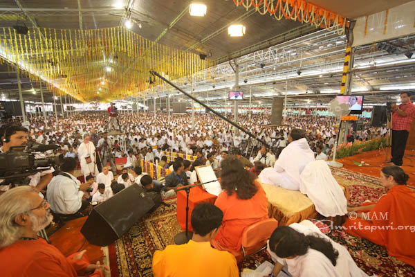 devotees listening to Amma Amma addressing visitors and ashram residents on her 57th birthday