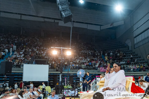 Amma gesturing the at the crowd Amma gesturing the at the crowd