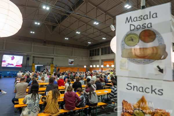 Sitting at the dinning hall, devotees listening to Amma  Sitting at the dinning hall, devotees listening to Amma