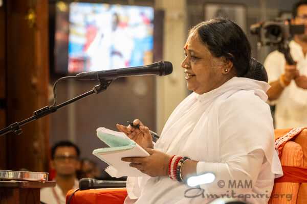 Amma initiating Vidyarambham